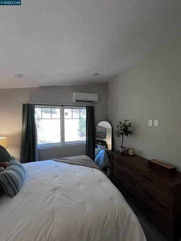 a bed sitting in a bedroom next to a window