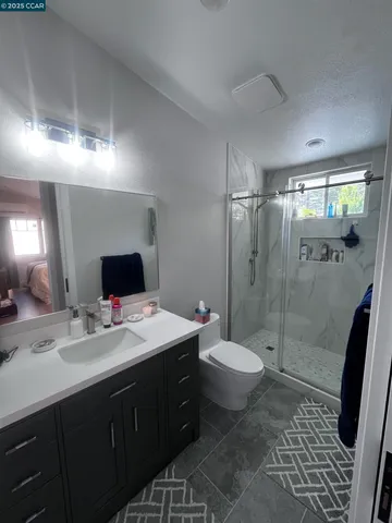 a bathroom with a double vanity sink toilet and shower