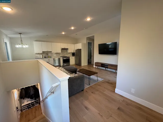 a view of kitchen with sink microwave and refrigerator