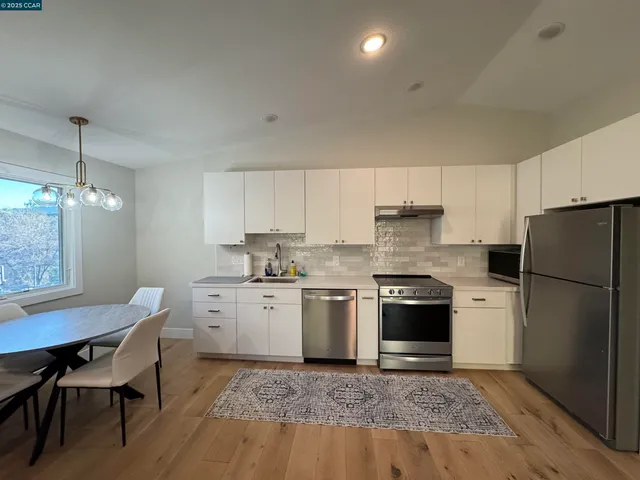 a kitchen with a stove a sink and a refrigerator