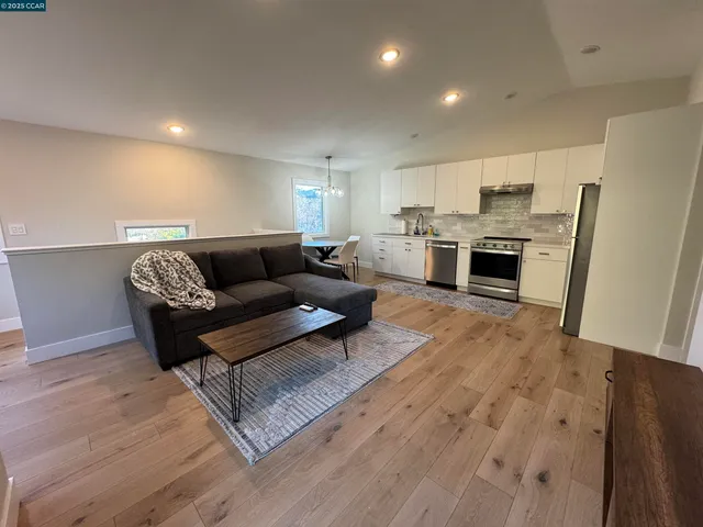 a living room with furniture and kitchen view