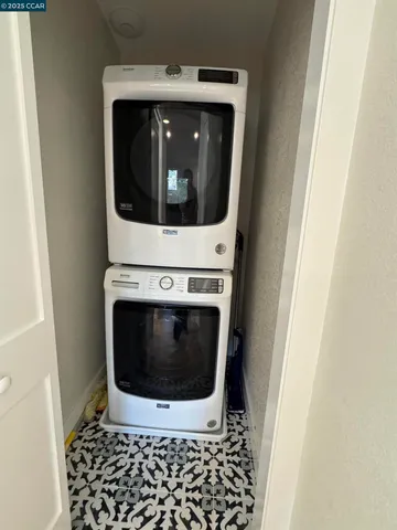 a utility room with wooden floor washer and dryer