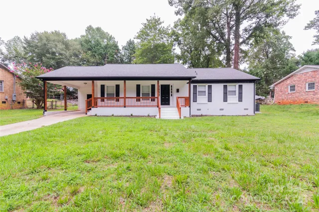 a view of a house with a yard porch and sitting area