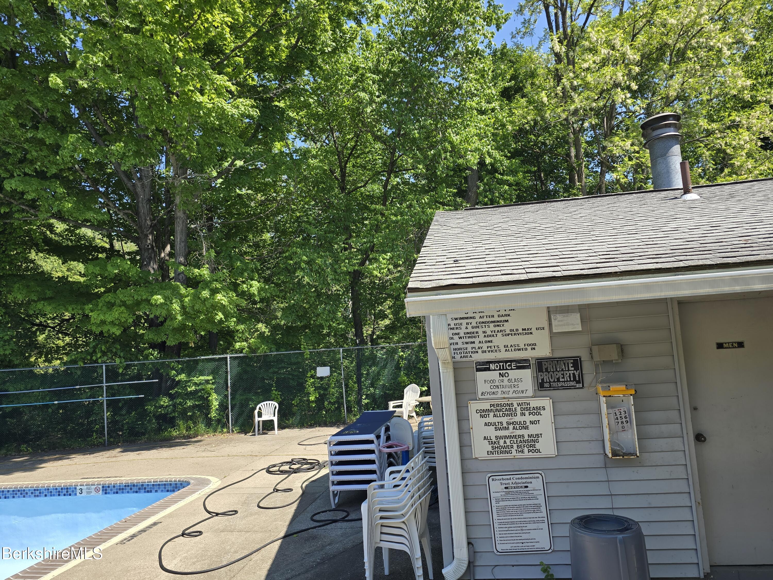 555 Russell Road, Unit J 65 Westfield, MA 01085 - Photo 18 of 20 a view of a patio with table and chairs with wooden floor and fence