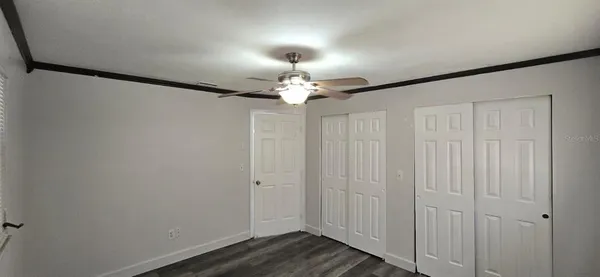 a view of a chandelier fan and wooden floor