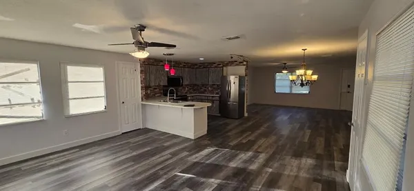 a view of a kitchen and microwave area