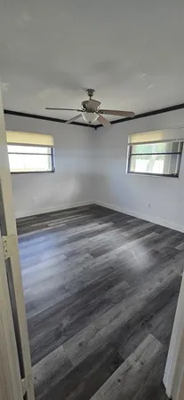 a view of a room with wooden floor