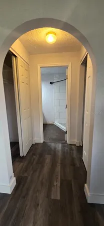 an empty room with wooden floor and a window