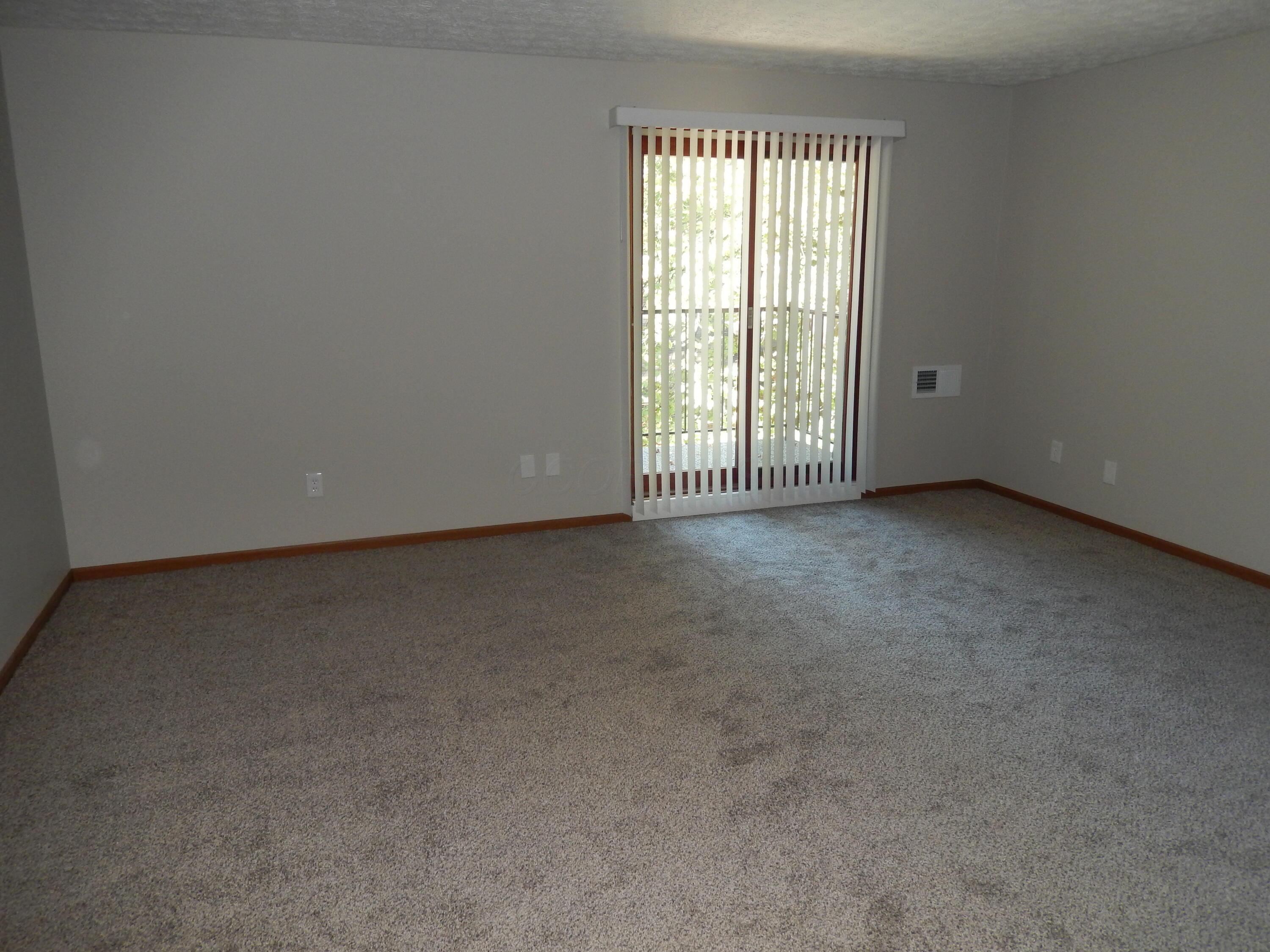 4117 Karl Road, Unit 302 Columbus, OH 43224 - Photo 8 of 33 Living Room with sliding door to balcony
