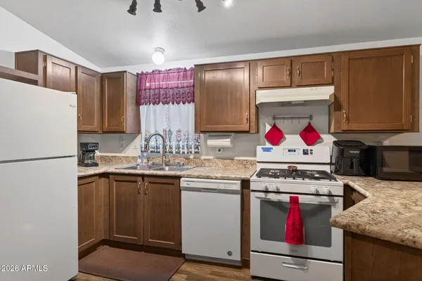 a kitchen with stainless steel appliances granite countertop a stove and a refrigerator