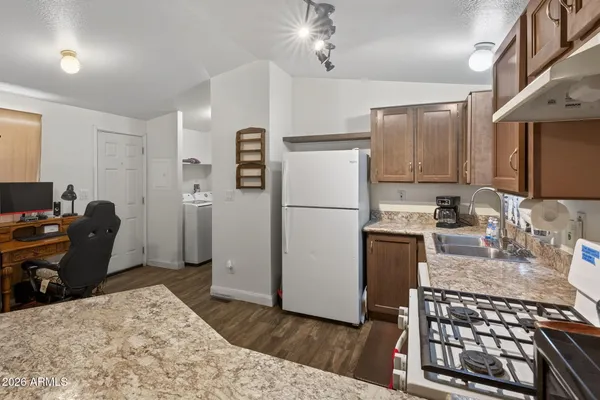 a kitchen with sink refrigerator and cabinets
