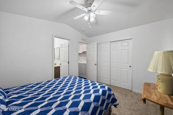 a bedroom with a bed and a lamp