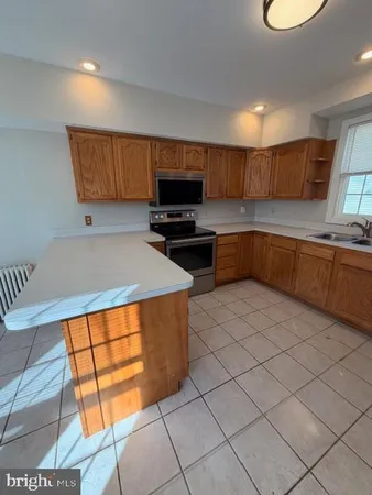 a kitchen with stainless steel appliances granite countertop a sink and a stove