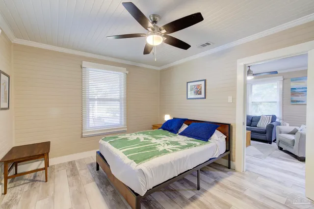 a bedroom with a bed and a chair