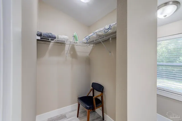 a room with a chair and a window