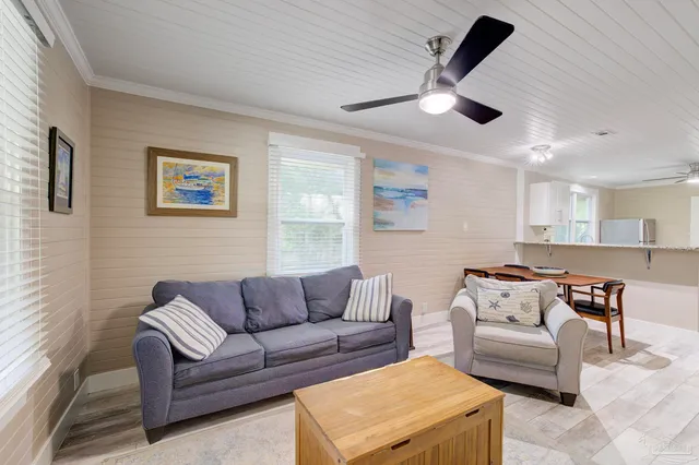 a living room with furniture and a ceiling fan