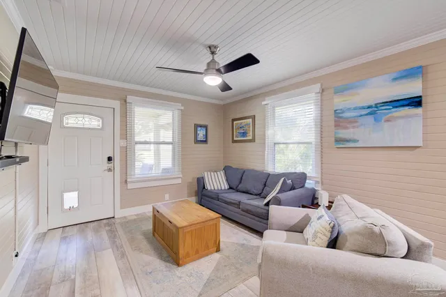 a living room with furniture and a flat screen tv