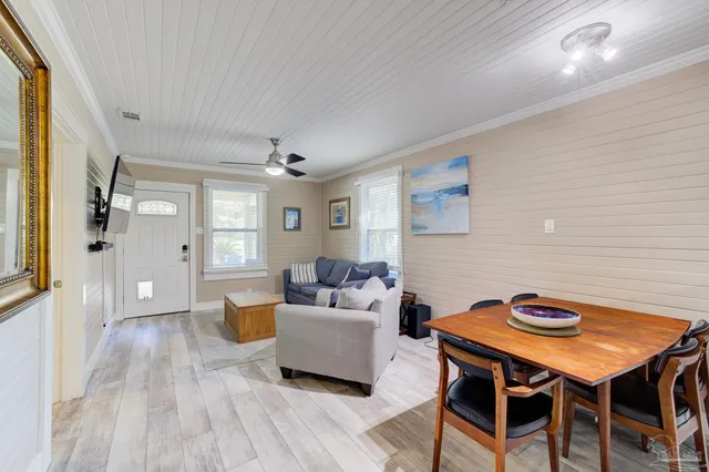 a living room with furniture a table and wooden floor