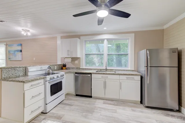 a kitchen with white cabinets and white appliances