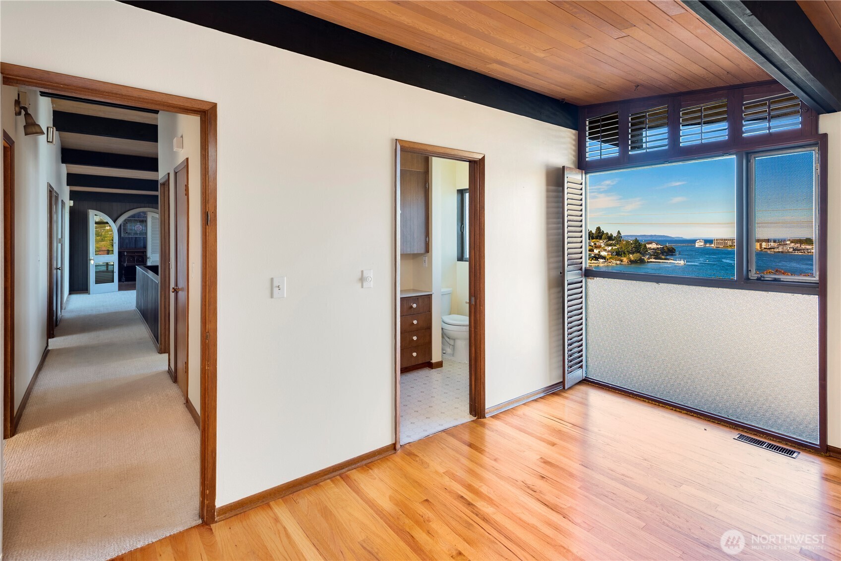 3653 West Commodore Way Seattle, WA 98199 - Photo 18 of 35 a view of a hallway with wooden floor and a kitchen