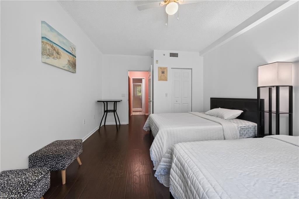 1105 Reserve Court, Unit 206 Naples, FL 34105 - Photo 14 of 23 a bedroom with two beds and a lamp