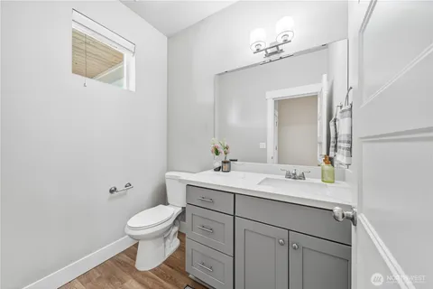 a bathroom with a toilet sink and mirror