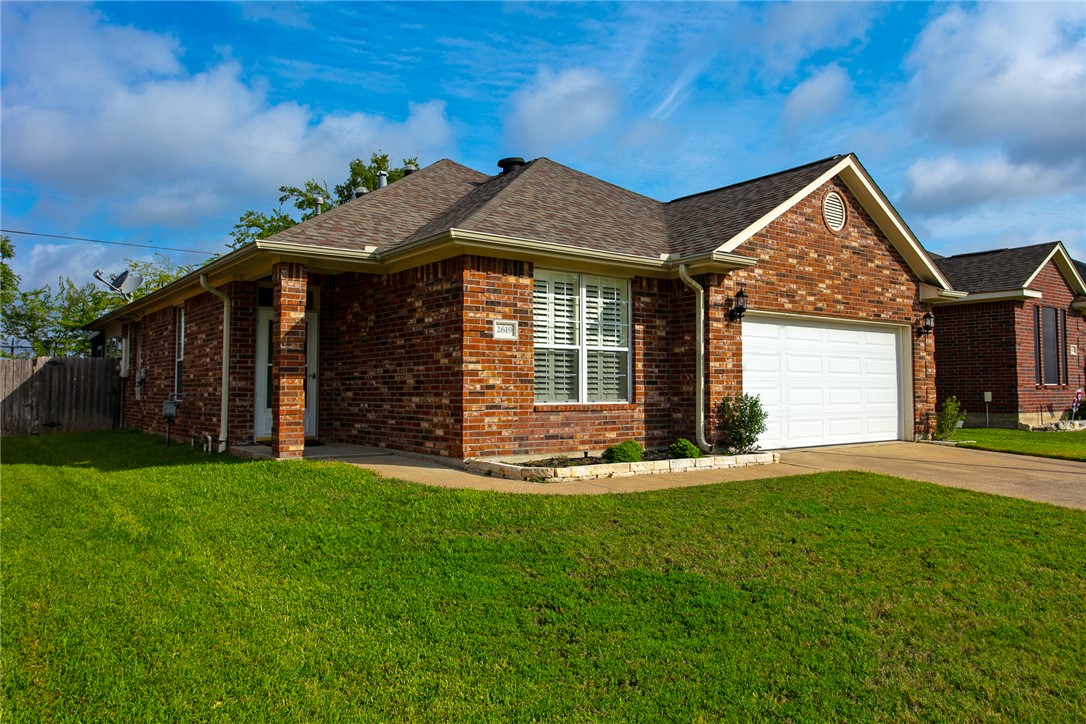 2619 Trophy Drive Bryan, TX 77802 - Photo 2 of 28 a front view of a house with a garden