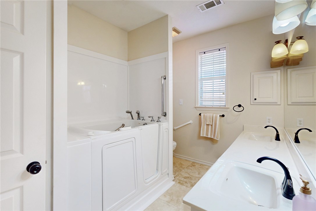 2619 Trophy Drive Bryan, TX 77802 - Photo 21 of 28 a bathroom with a double vanity sink and a mirror