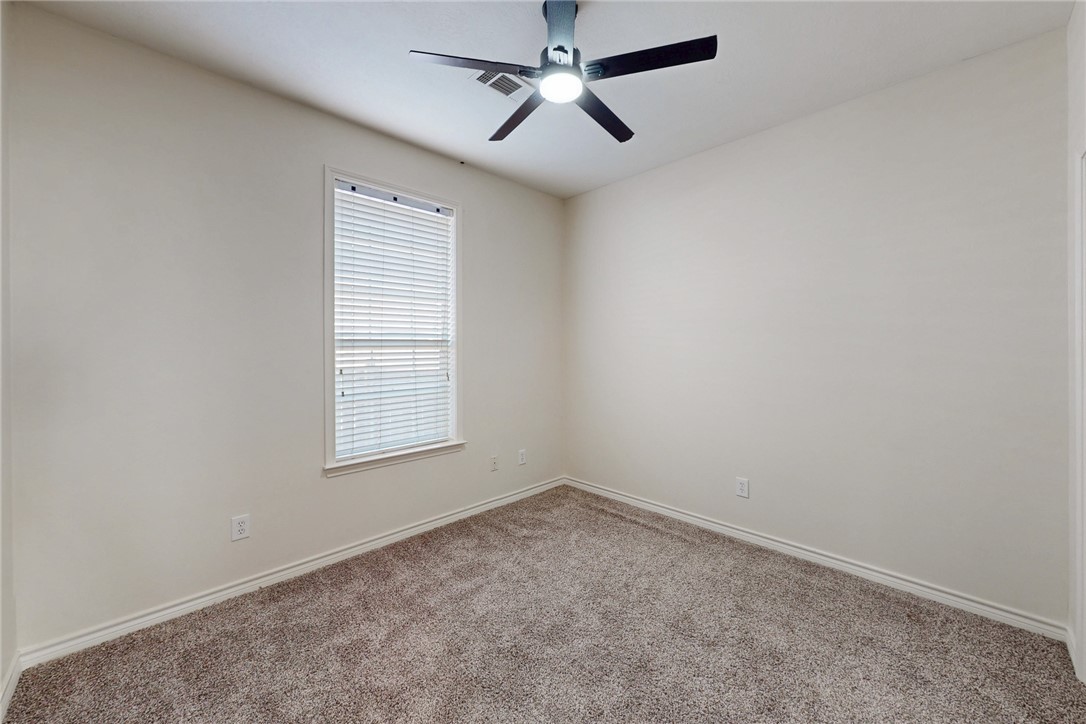 2619 Trophy Drive Bryan, TX 77802 - Photo 23 of 28 an empty room with a window and a fan
