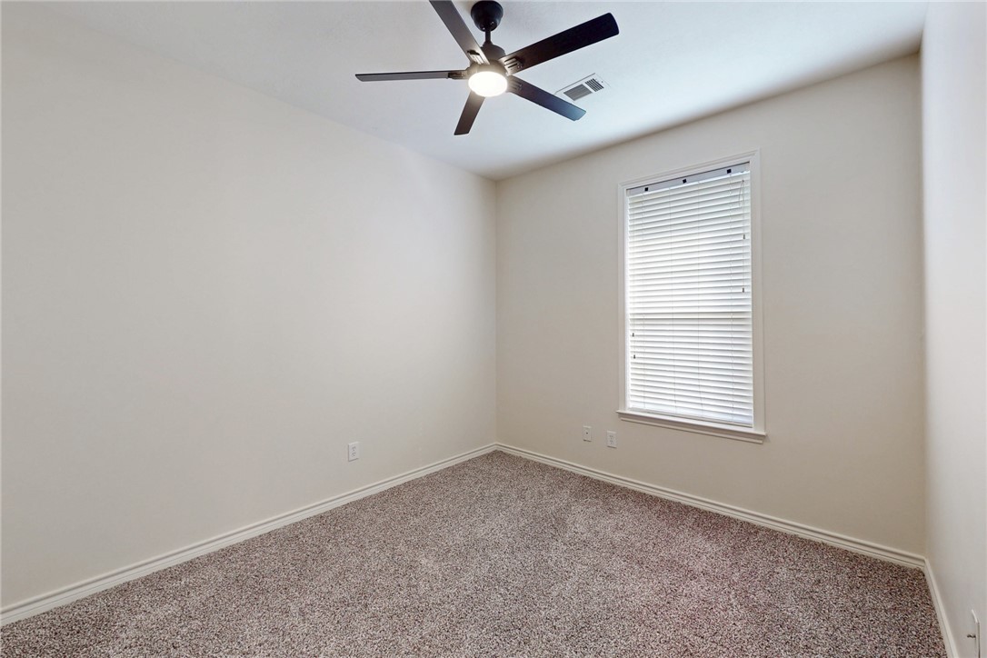 2619 Trophy Drive Bryan, TX 77802 - Photo 27 of 28 an empty room with a window and a fan