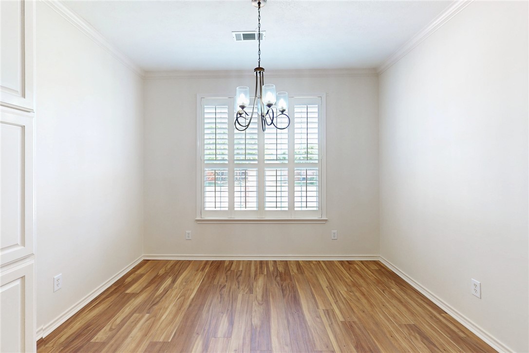 2619 Trophy Drive Bryan, TX 77802 - Photo 8 of 28 a view of an empty room with wooden floor and a window