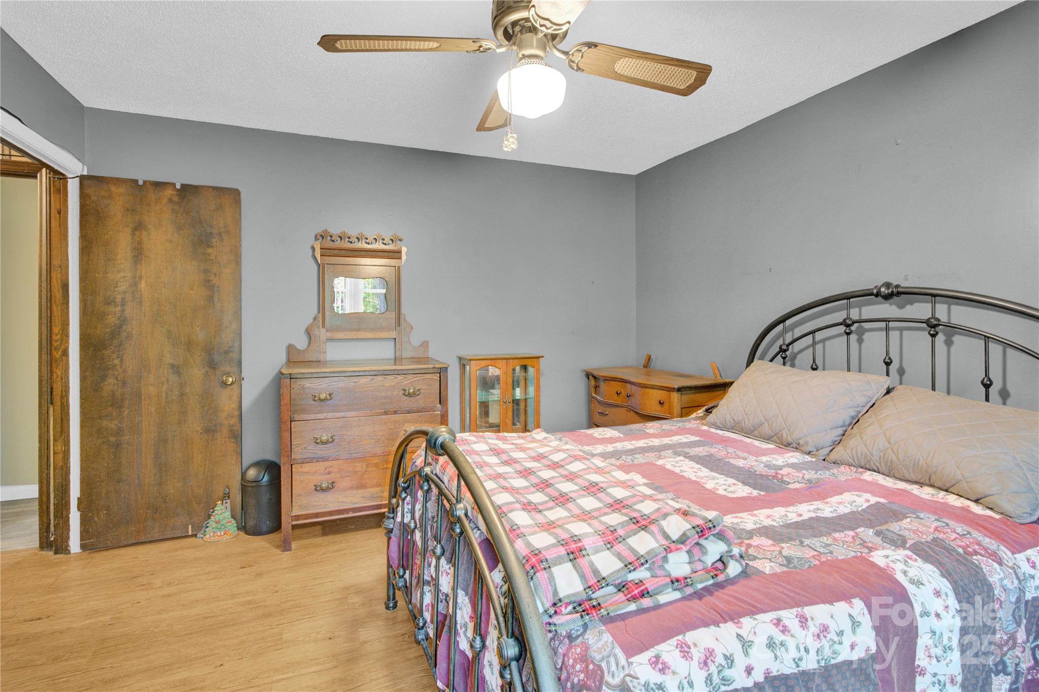 841 Knowles Drive Dallas, NC 28034 - Photo 16 of 46 a bedroom with a bed and a chandelier