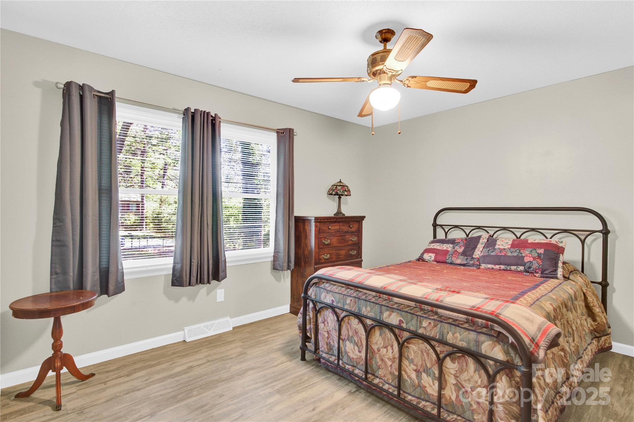 841 Knowles Drive Dallas, NC 28034 - Photo 17 of 46 a bedroom with a bed and a chandelier
