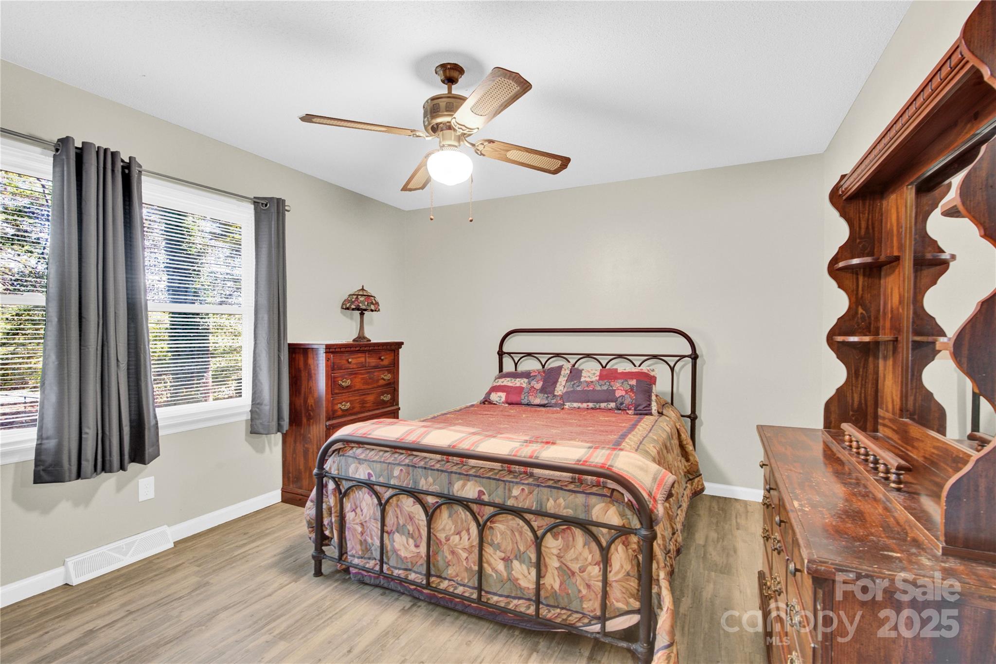 841 Knowles Drive Dallas, NC 28034 - Photo 22 of 46 a bedroom with a bed and a chandelier