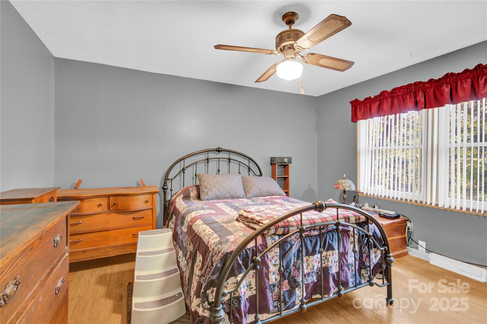 841 Knowles Drive Dallas, NC 28034 - Photo 23 of 46 a bedroom with a bed and a chandelier