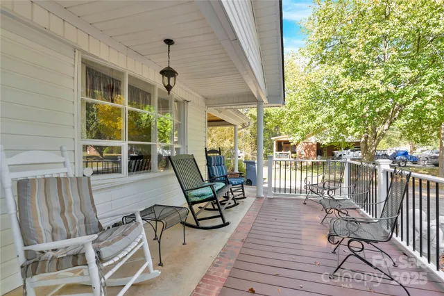 a view of a chairs and table in patio with wooden fence