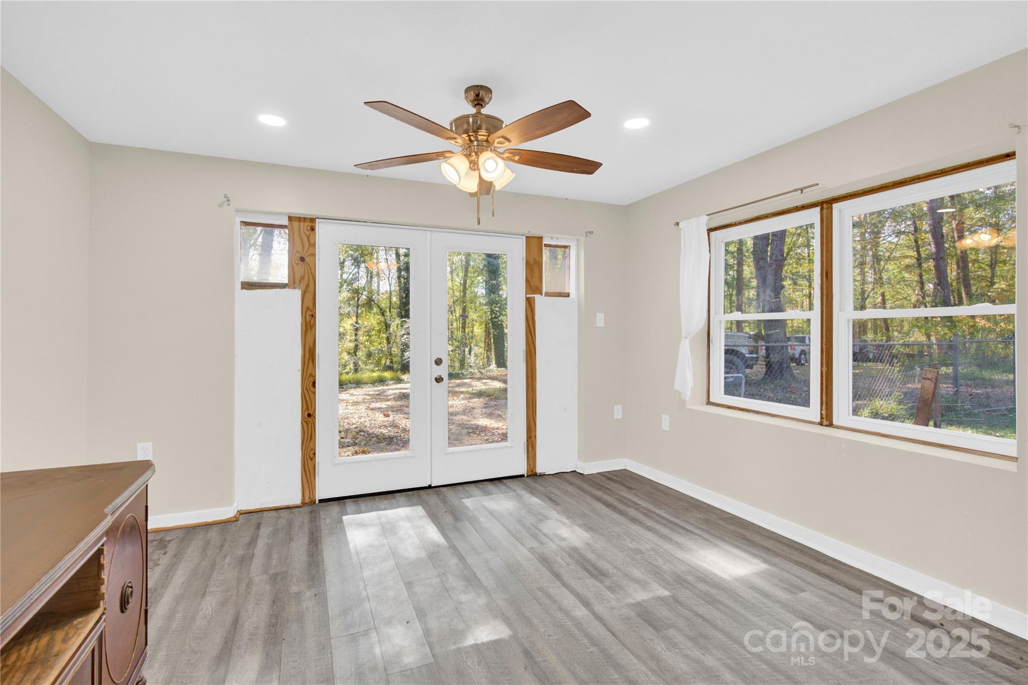 841 Knowles Drive Dallas, NC 28034 - Photo 35 of 46 a view of an empty room with a window and wooden floor