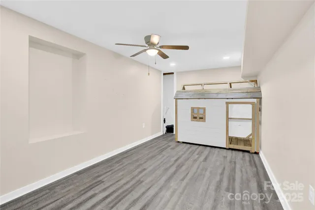 a view of a kitchen with a sink and wooden floor