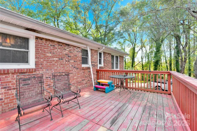 a balcony with furniture and wooden floor