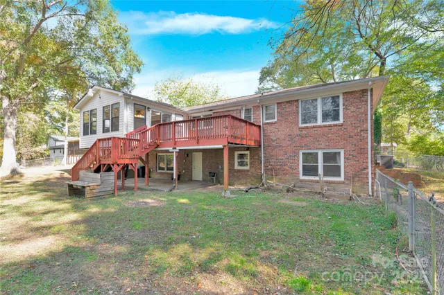 a view of a house with a yard and sitting area