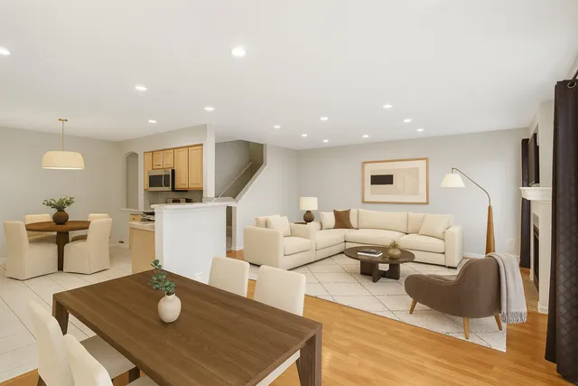 a living room with furniture and view of kitchen