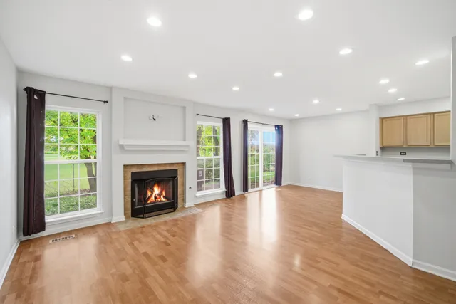 a view of an empty room with a fireplace and a window
