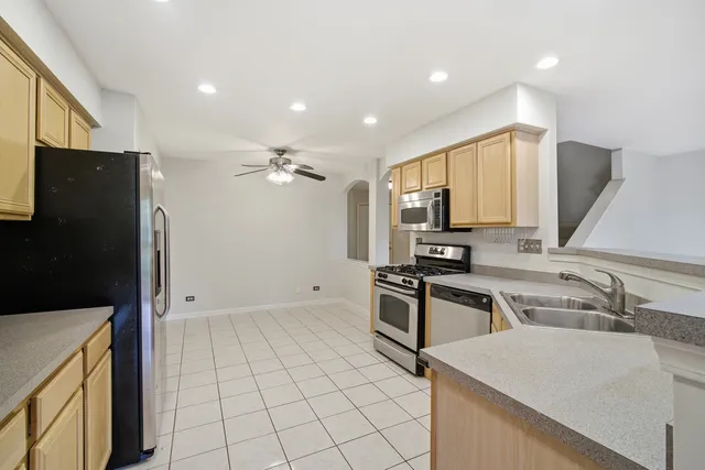 a kitchen with stainless steel appliances granite countertop a refrigerator and a sink