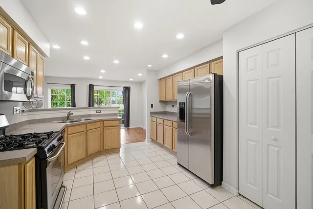 a kitchen with stainless steel appliances granite countertop a refrigerator and a sink
