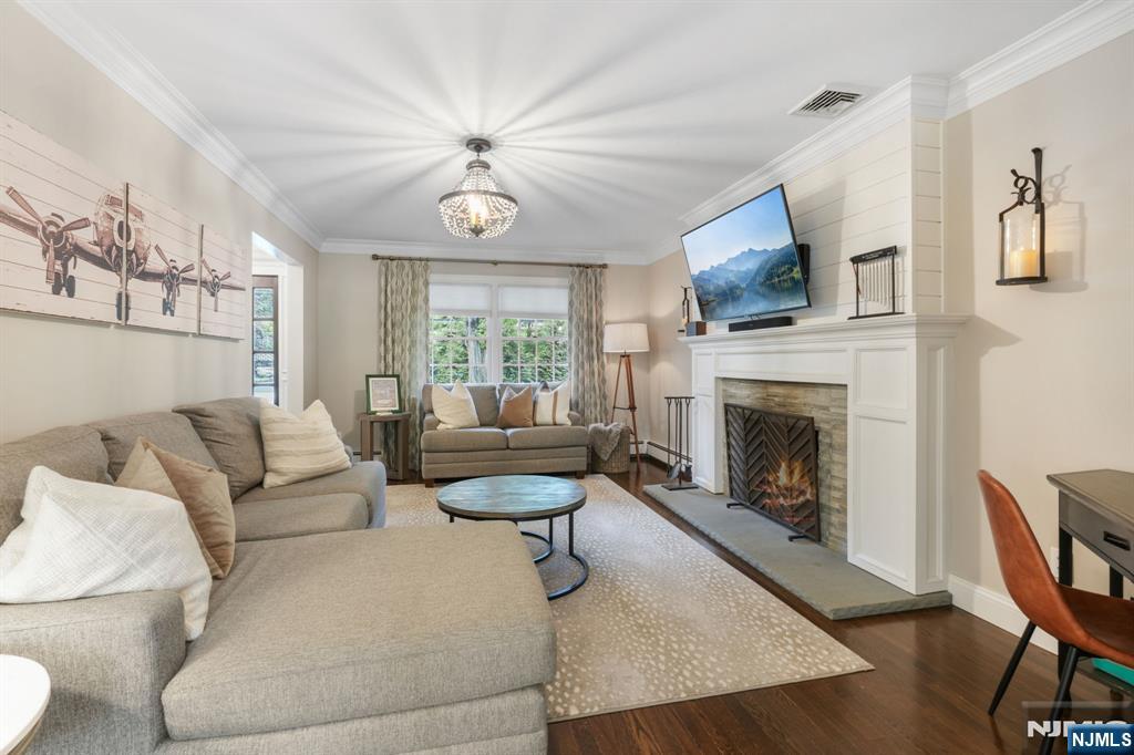 1015 High Mountain Road Franklin Lakes, NJ 07417 - Photo 13 of 48 a living room with furniture a fireplace and a flat screen tv