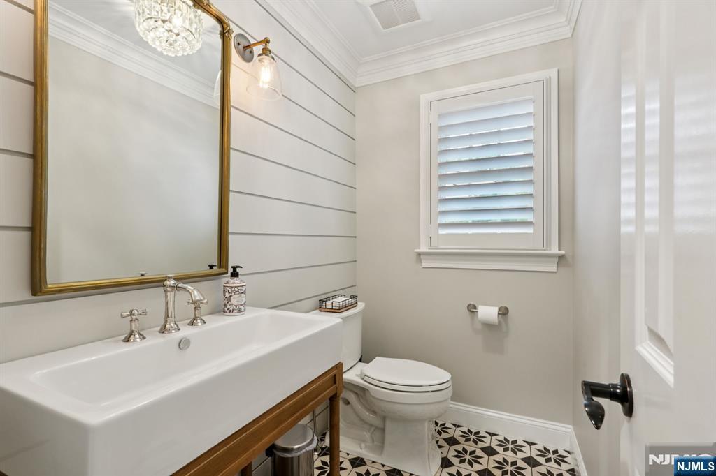 1015 High Mountain Road Franklin Lakes, NJ 07417 - Photo 20 of 48 a bathroom with a sink a toilet and mirror