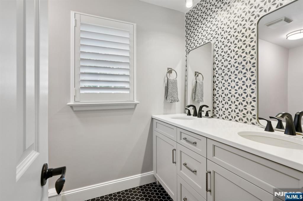 1015 High Mountain Road Franklin Lakes, NJ 07417 - Photo 29 of 48 a bathroom with a sink a vanity and a mirror