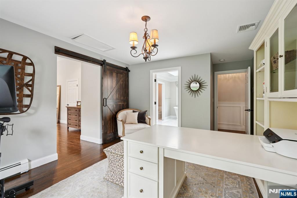 1015 High Mountain Road Franklin Lakes, NJ 07417 - Photo 33 of 48 a spacious bedroom with a bed and a chandelier