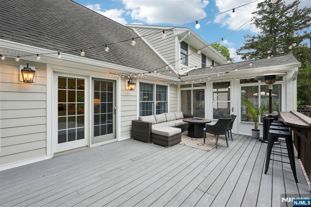 1015 High Mountain Road Franklin Lakes, NJ 07417 - Photo 42 of 48 a view of a patio with couches fire pit and wooden floor