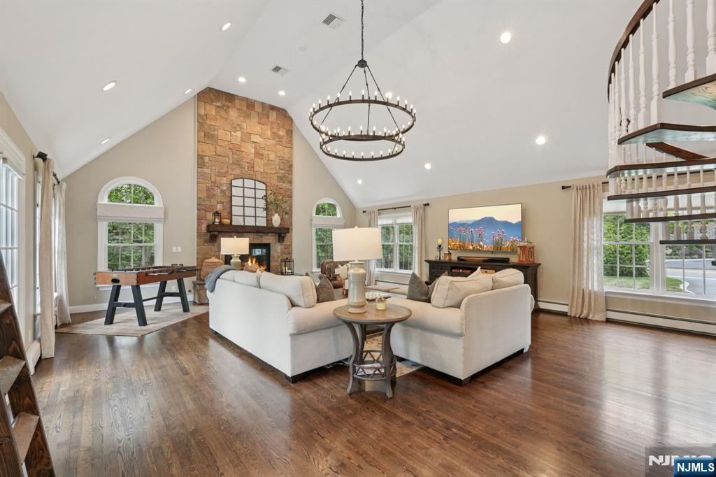 1015 High Mountain Road Franklin Lakes, NJ 07417 - Photo 10 of 48 a living room with furniture a wooden floor and a chandelier